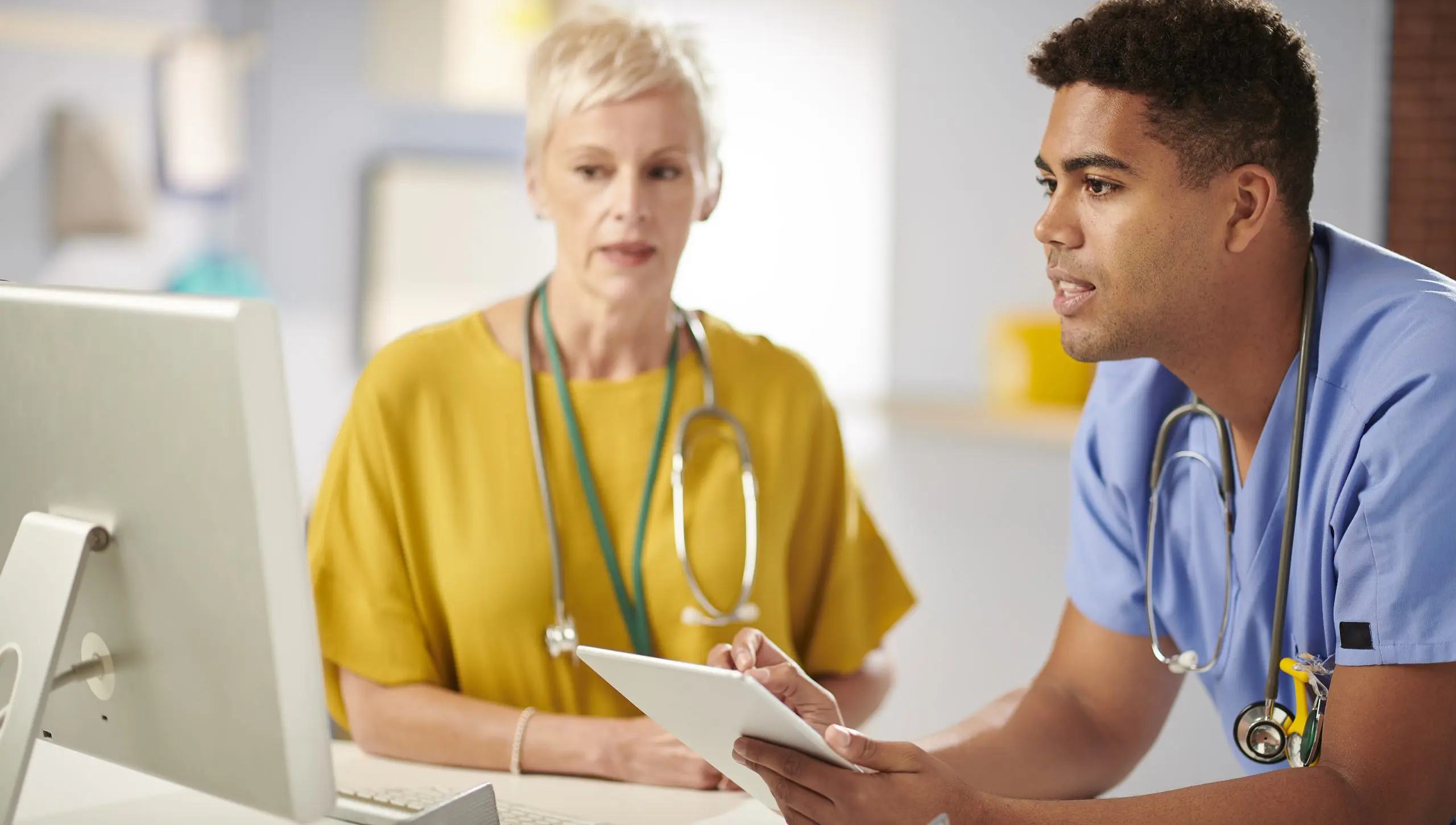 Intern - doctor and trainee discussing medical notes