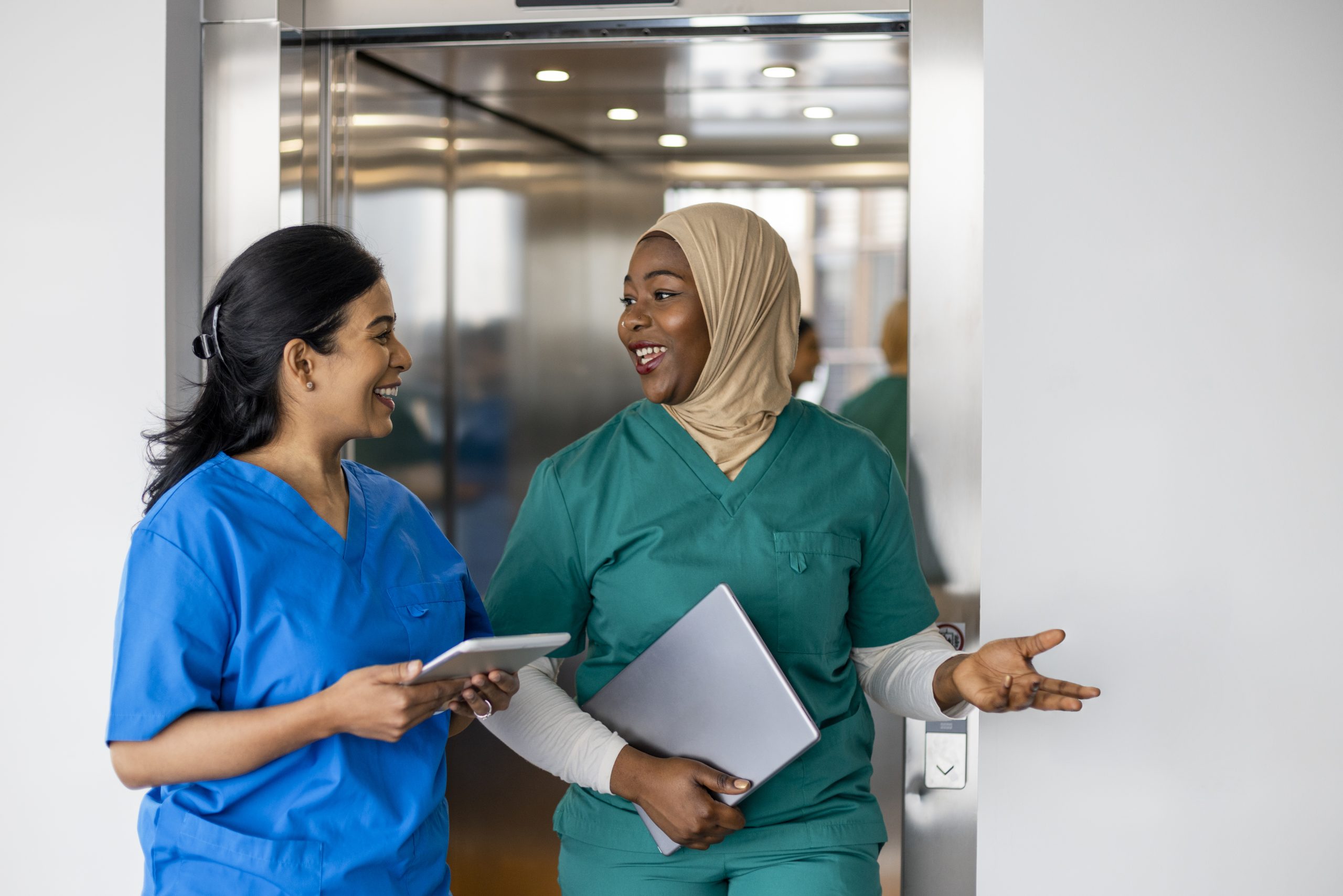 Two doctors leaving an elevator