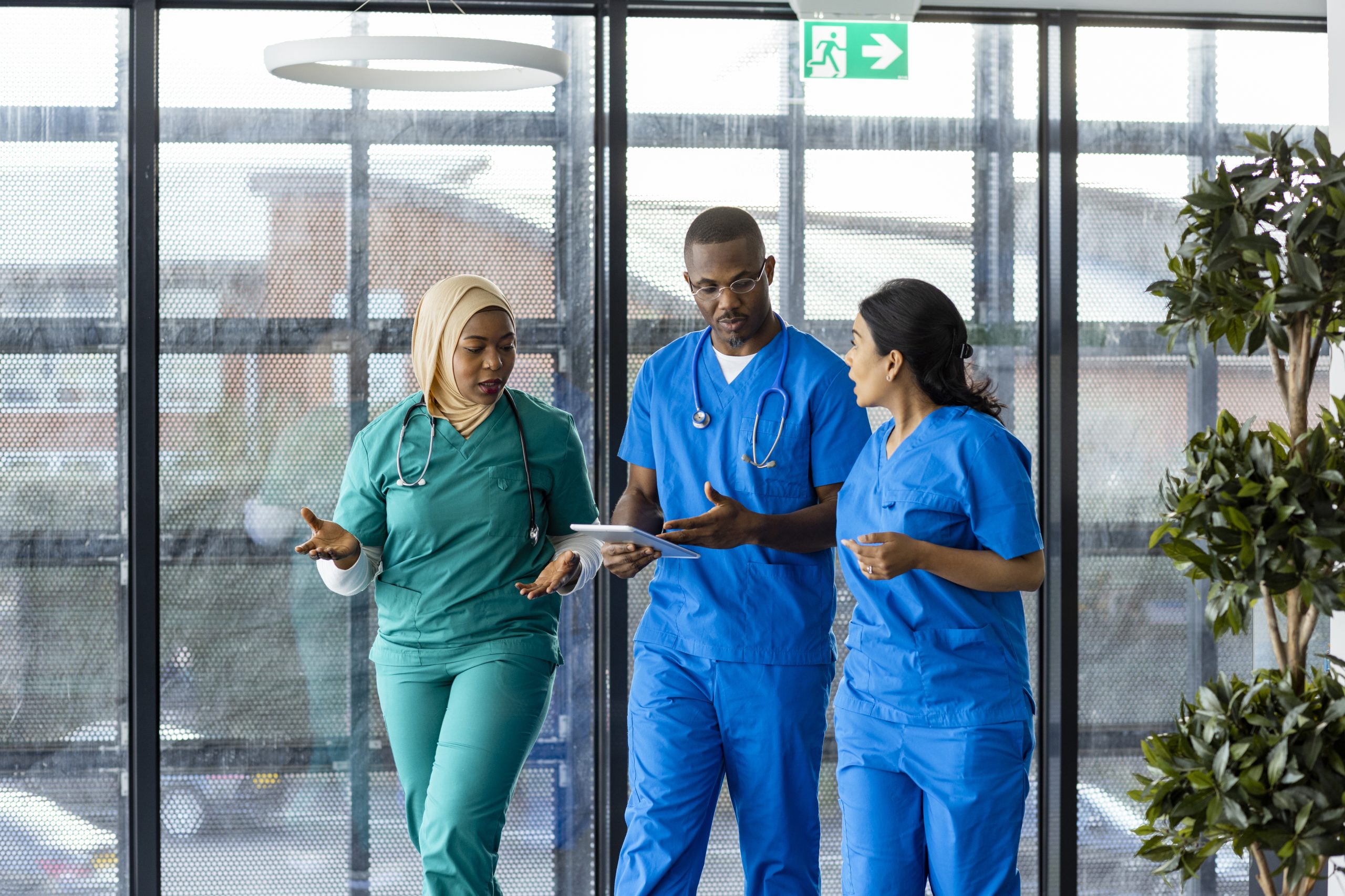 Three doctors walk through hospital